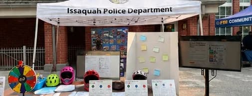 National Night Out bike and e-bike safety station under the Issaquah Police Department canopy
