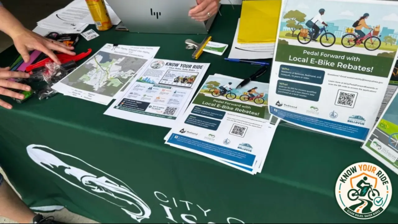 Know Your Ride educational materials displayed on a community event table with local e-bike rebate information.